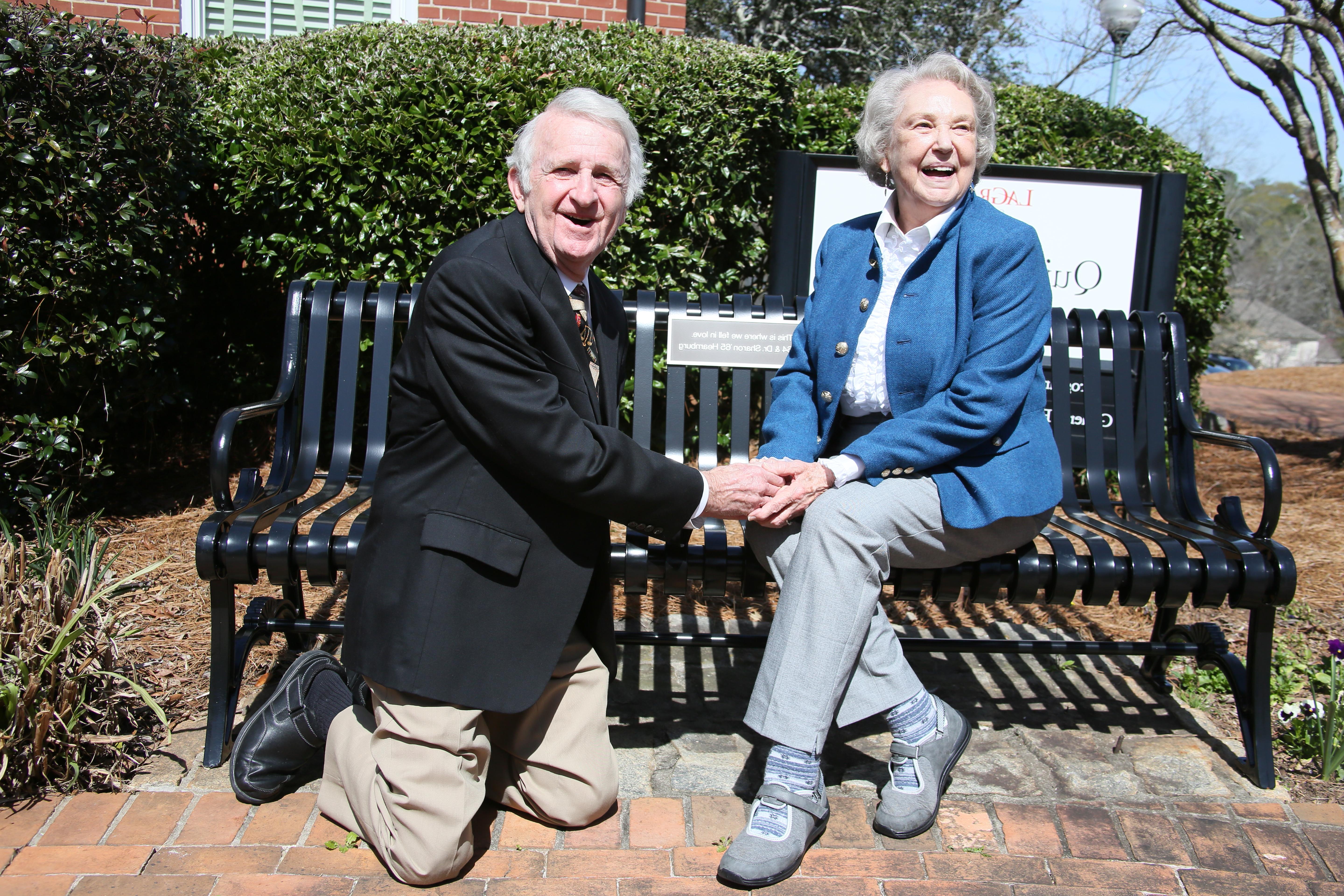 Bill '64 and Sharon '65 Hearnburg recreate their engagement in front of their bench outside the Quillian building. 